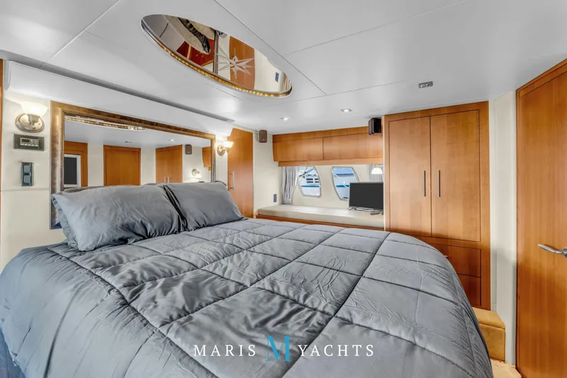  Yacht Photos Pics Luxurious bedroom interior of 2009 Regal 52 Sport Coupe yacht with modern wood finishes.