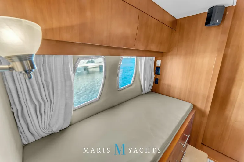  Yacht Photos Pics Interior cabin of 2009 Regal 52 Sport Coupe yacht with bed and windows.