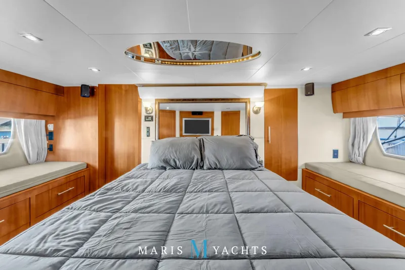  Yacht Photos Pics Luxurious bedroom interior of 2009 Regal 52 Sport Coupe yacht with modern wood finishes.