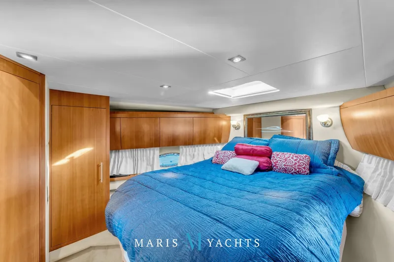 Yacht Photos Pics Luxurious cabin interior of 2009 Regal 52 Sport Coupe yacht with vibrant bedding.