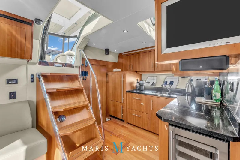  Yacht Photos Pics Luxurious interior of 2009 Regal 52 Sport Coupe yacht with modern kitchen and wooden finishes.