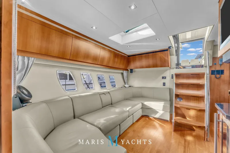  Yacht Photos Pics Luxurious interior of 2009 Regal 52 Sport Coupe yacht with elegant seating and wooden accents.