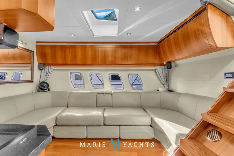  Yacht Photos Pics Luxurious interior of 2009 Regal 52 Sport Coupe yacht with elegant seating and wood finishes.