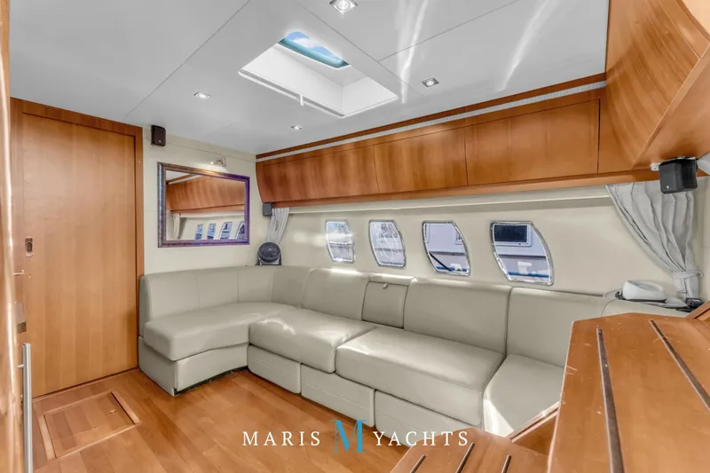  Yacht Photos Pics Luxurious interior of 2009 Regal 52 Sport Coupe yacht with leather seating and wood accents.
