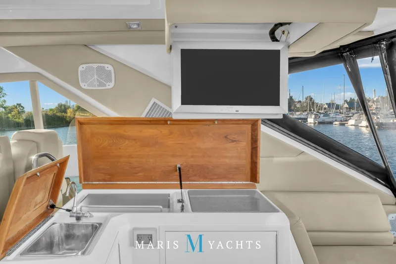  Yacht Photos Pics Interior of 2009 Regal 52 Sport Coupe yacht with sink and TV, marina view.