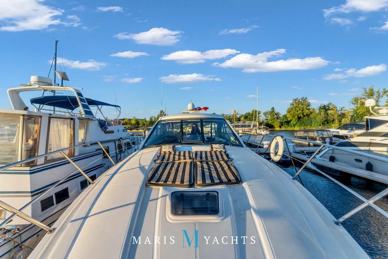  Yacht Photos Pics 2009 Regal 52 Sport Coupe yacht docked at marina under blue sky.