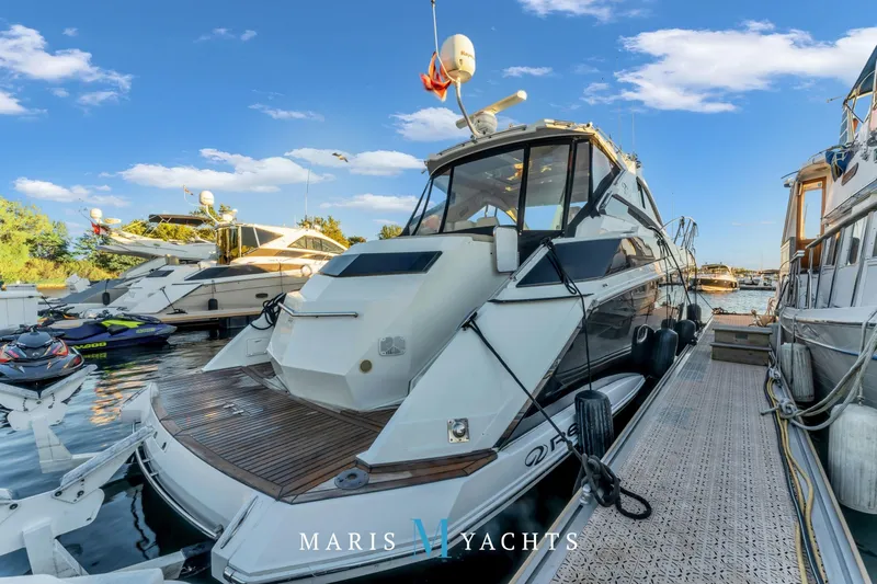  Yacht Photos Pics 2009 Regal 52 Sport Coupe yacht docked at marina under clear blue sky.