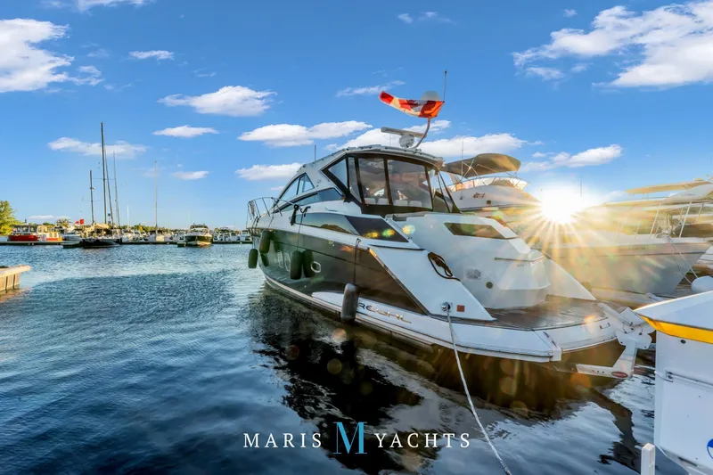  Yacht Photos Pics 2009 Regal 52 Sport Coupe yacht docked in a sunny marina.