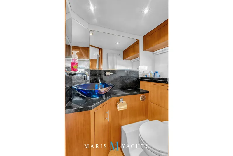  Yacht Photos Pics Luxurious bathroom in 2009 Regal 52 Sport Coupe yacht with modern fixtures and elegant design.