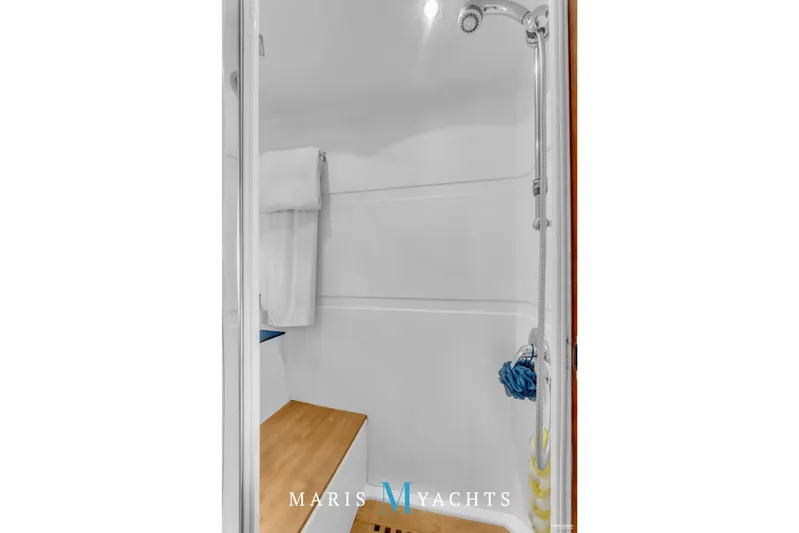  Yacht Photos Pics Shower area in 2009 Regal 52 Sport Coupe yacht with wooden bench and modern fixtures.