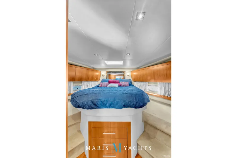  Yacht Photos Pics Luxurious bedroom interior of 2009 Regal 52 Sport Coupe yacht with blue bedding.
