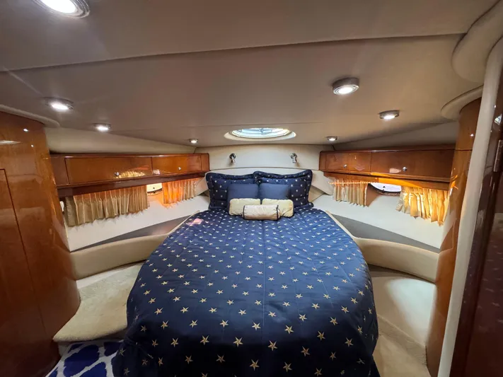 Aquaholics Yacht Photos Pics Luxurious cabin interior of 2008 Regal Commodore 4460 yacht with star-patterned bedding.