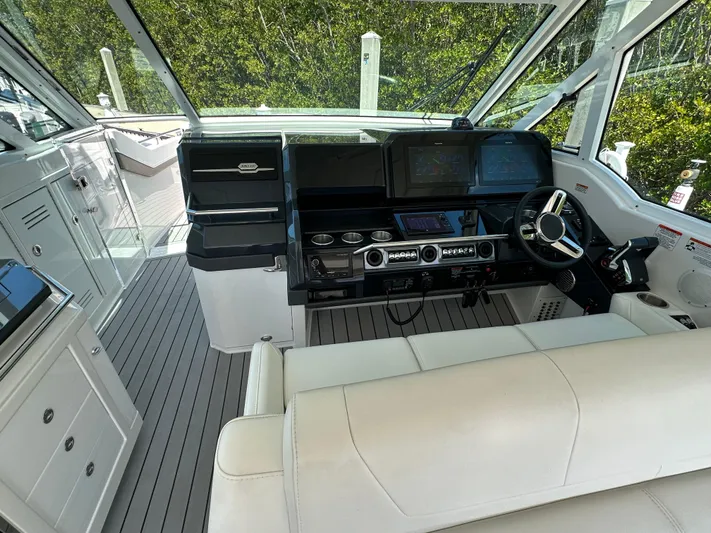 Harvest Time Yacht Photos Pics 2022 Formula 380 Super Sport Crossover cockpit with modern controls and luxurious seating.