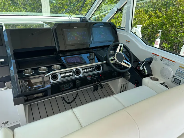 Harvest Time Yacht Photos Pics 2022 Formula 380 Super Sport Crossover helm with modern controls and sleek design.