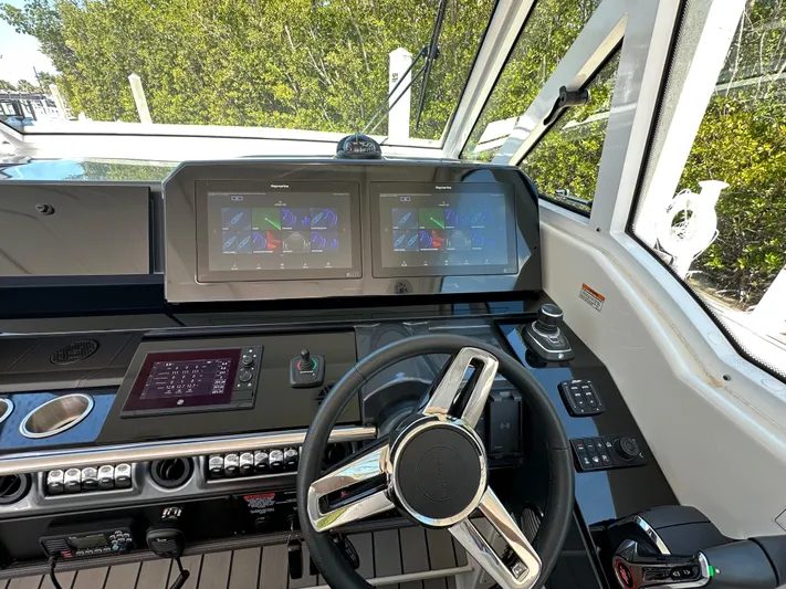 Harvest Time Yacht Photos Pics 2022 Formula 380 Super Sport Crossover helm with dual displays and modern controls.