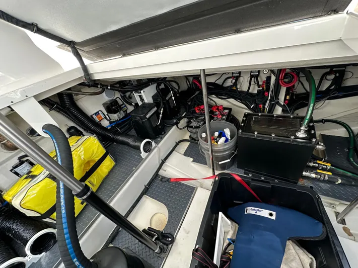 Harvest Time Yacht Photos Pics Engine compartment of 2022 Formula 380 Super Sport Crossover with equipment and storage items.