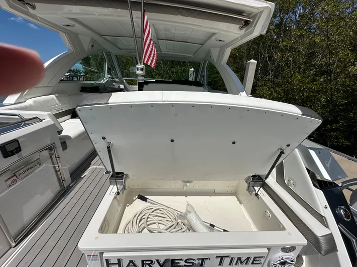 Harvest Time Yacht Photos Pics 2022 Formula 380 Super Sport Crossover boat with open storage compartment, "Harvest Time" nameplate.