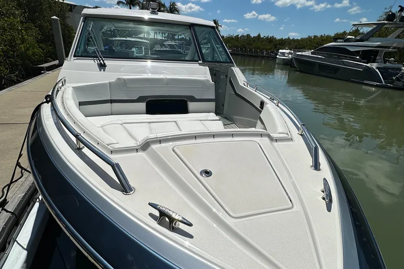 Harvest Time Yacht Photos Pics 2022 Formula 380 Super Sport Crossover boat docked on calm water under a clear sky.