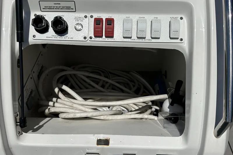 Harvest Time Yacht Photos Pics Control panel and storage compartment on a 2022 Formula 380 Super Sport Crossover boat.