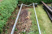 Metal frame on grass, surrounded by hedges, Custom Snipa 2023 model.