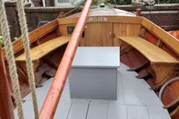 Wooden boat interior with benches and mast, Custom Snipa model, 2023.