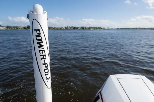  Yacht Photos Pics 2024 Islamorada Boatworks 24 with Power-Pole on calm water, clear sky background.