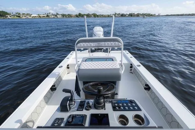 Yacht Photos Pics 2024 Islamorada Boatworks 24, sleek interior, advanced controls, cruising on calm waters.