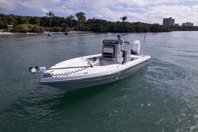  Yacht Photos Pics 2024 Islamorada Boatworks 24 on calm water near a tropical shoreline.