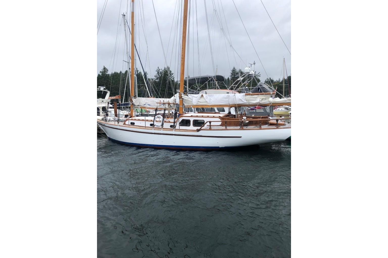 1966 Allen Mackay Gaff Rigged Top Sail Schooner docked in a marina.