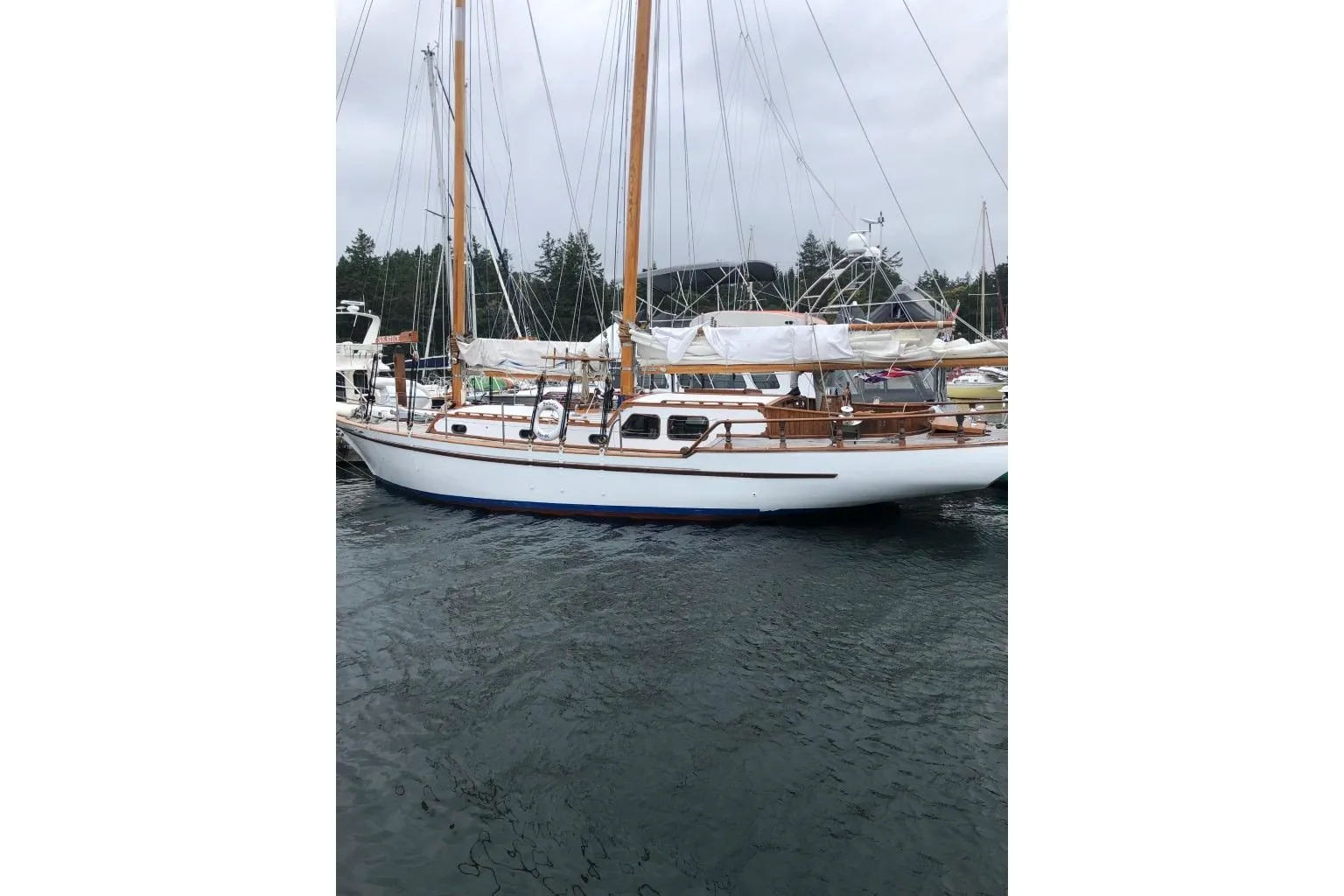 1966 Allen Mackay Gaff Rigged Top Sail Schooner docked in a marina.