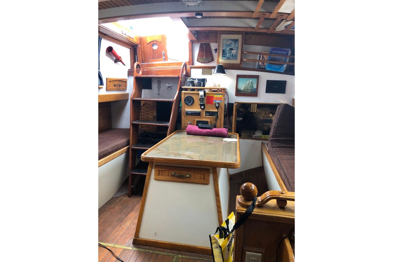 Interior of 1966 Allen Mackay Gaff Rigged Top Sail Schooner, featuring wooden furnishings and nautical decor.