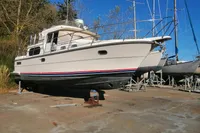 1996 Nimbus Trawler 37 boat on dry dock under clear blue sky.