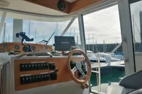 Interior helm of 1996 Nimbus Trawler 37 with steering wheel and control panel.