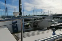 Nimbus Trawler 37, 1996 model, docked at marina with clear sky and sailboats.