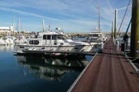 Nimbus Trawler 37, 1996 model, docked at marina with clear blue sky.
