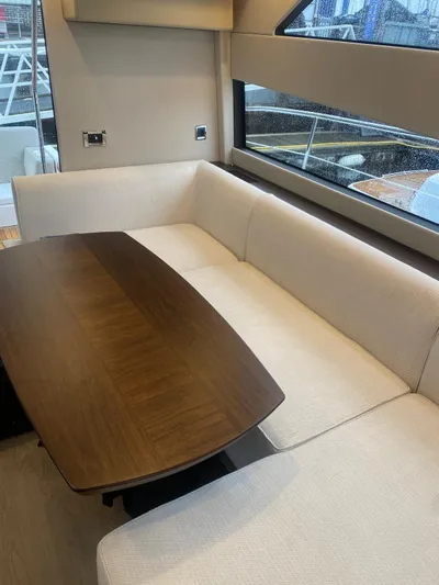 Waypoint Yacht Photos Pics 2024 Fairline Squadron 50 yacht interior with elegant dining area and large window view.