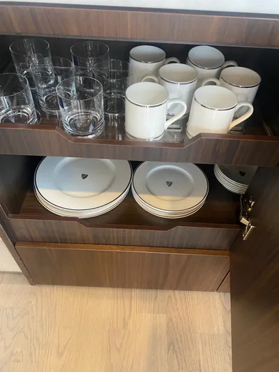 Waypoint Yacht Photos Pics Cabinet with glassware and dinnerware on Fairline Squadron 50 yacht, 2024 model.