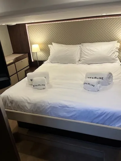 Waypoint Yacht Photos Pics Luxurious bedroom in 2024 Fairline Squadron 50 yacht with elegant bedding and ambient lighting.