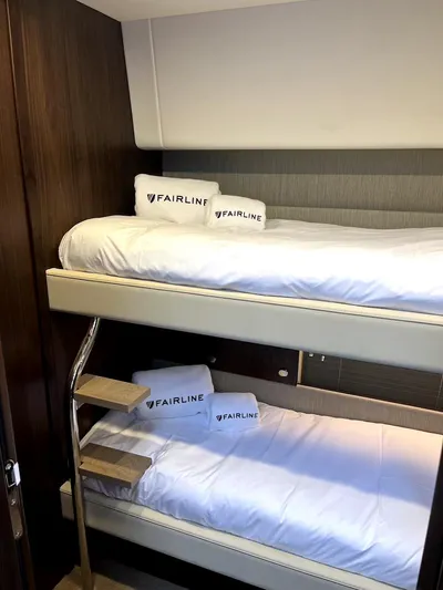 Waypoint Yacht Photos Pics 2024 Fairline Squadron 50 yacht interior with bunk beds and branded pillows.