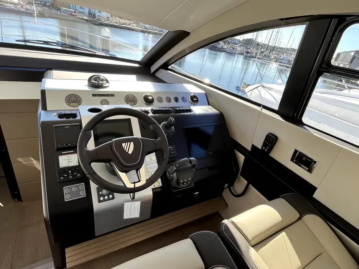 Waypoint Yacht Photos Pics 2024 Fairline Squadron 50 yacht helm with modern controls and waterfront view.
