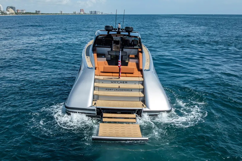 Why Her Yacht Photos Pics 2024 Wajer 55 HT yacht cruising in open water, rear view with city skyline.