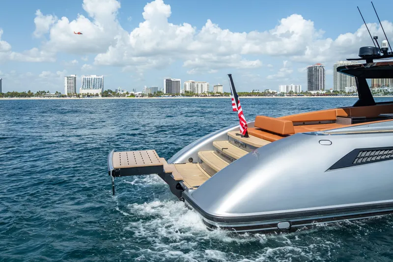Why Her Yacht Photos Pics 2024 Wajer 55 HT yacht on water, city skyline in background, American flag displayed.