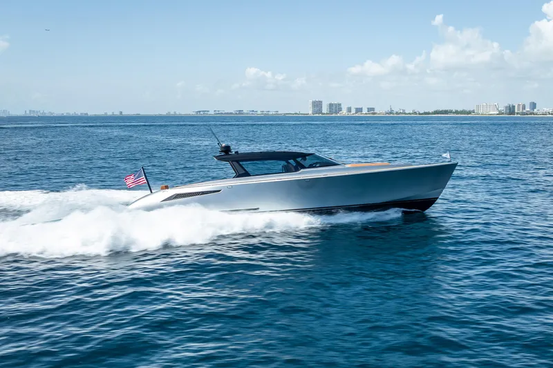Why Her Yacht Photos Pics 2024 Wajer 55 HT yacht cruising on open water, city skyline in background.