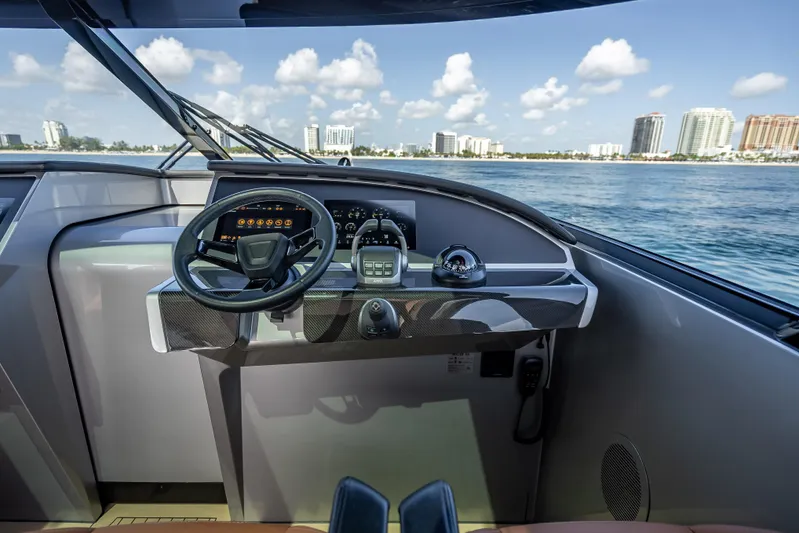 Why Her Yacht Photos Pics Helm of 2024 Wajer 55 HT yacht with modern controls, overlooking ocean and cityscape.