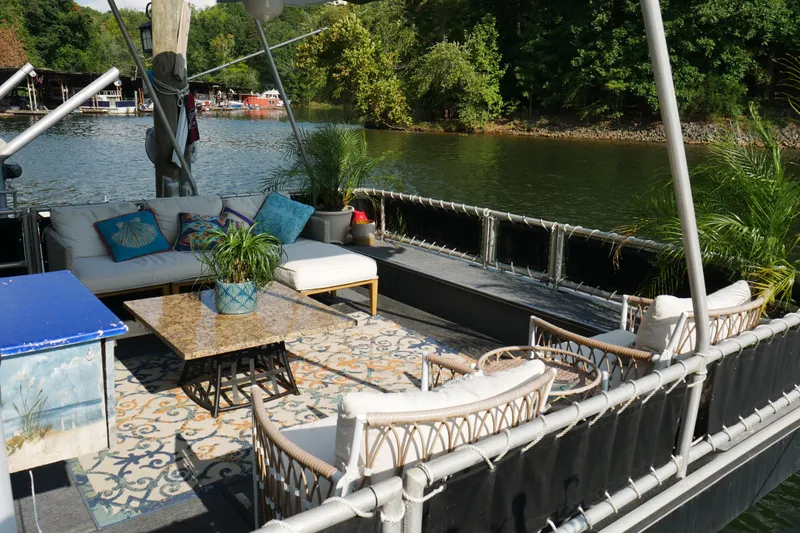  Yacht Photos Pics Luxurious 1996 STARDUST Cruiser boat deck with elegant seating and lush greenery.