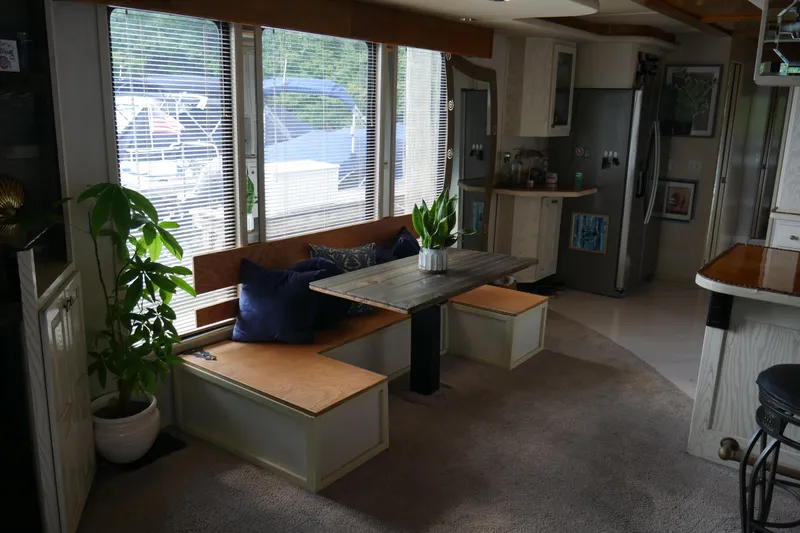  Yacht Photos Pics Cozy 1996 STARDUST Cruiser interior with dining area, plants, and modern kitchen.