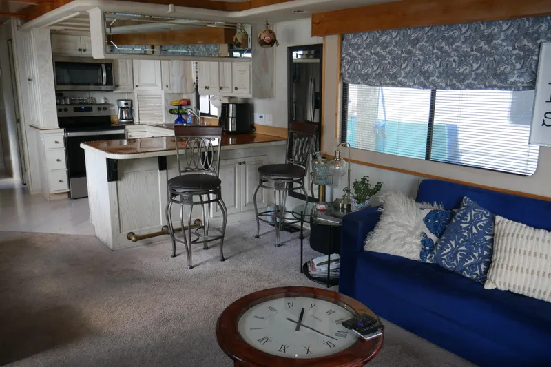  Yacht Photos Pics Interior of 1996 STARDUST Cruiser with kitchen, bar stools, and blue sofa.