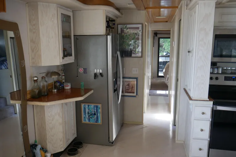  Yacht Photos Pics 1996 STARDUST Cruiser kitchen interior with modern appliances and wooden cabinetry.