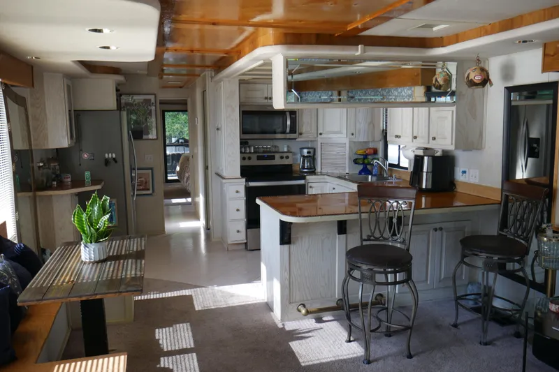  Yacht Photos Pics Luxurious 1996 STARDUST Cruiser kitchen with modern appliances and elegant wooden finishes.