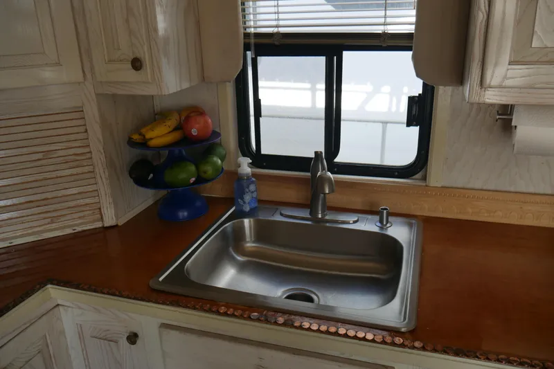  Yacht Photos Pics Kitchen sink in 1996 STARDUST Cruiser RV with fruit bowl and window view.